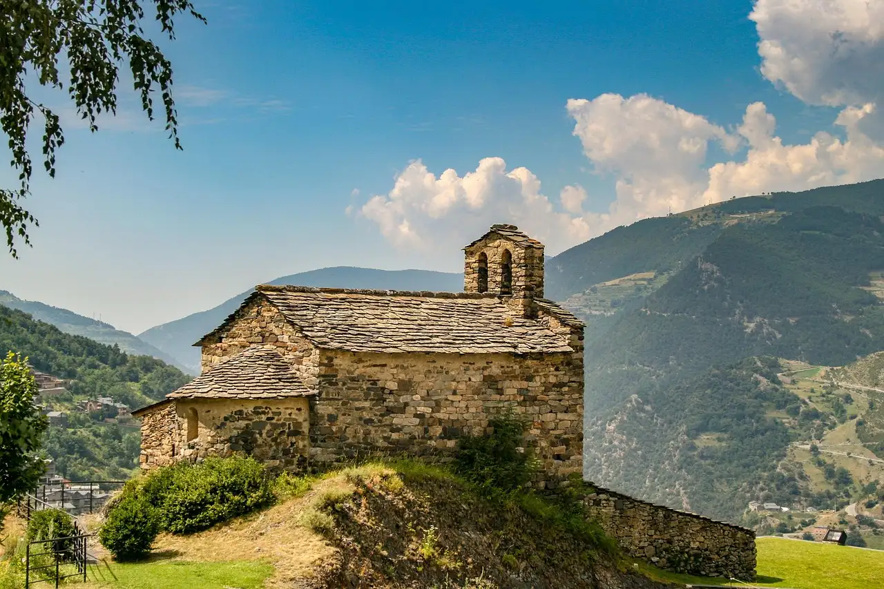 A small stone Romanesque chapel on a hillside in the Andorran Pyrenees