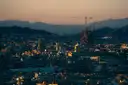 Barcelona at dusk, with the Sagrada Família and its cranes against the hills