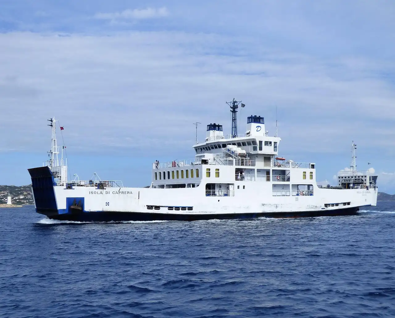 A white passenger ferry crossing a deep blue Mediterranean sea