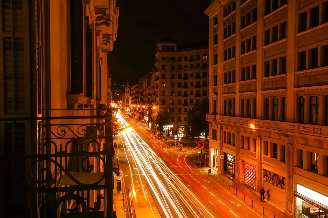 Light trails on a Barcelona street at night seen from a balcony