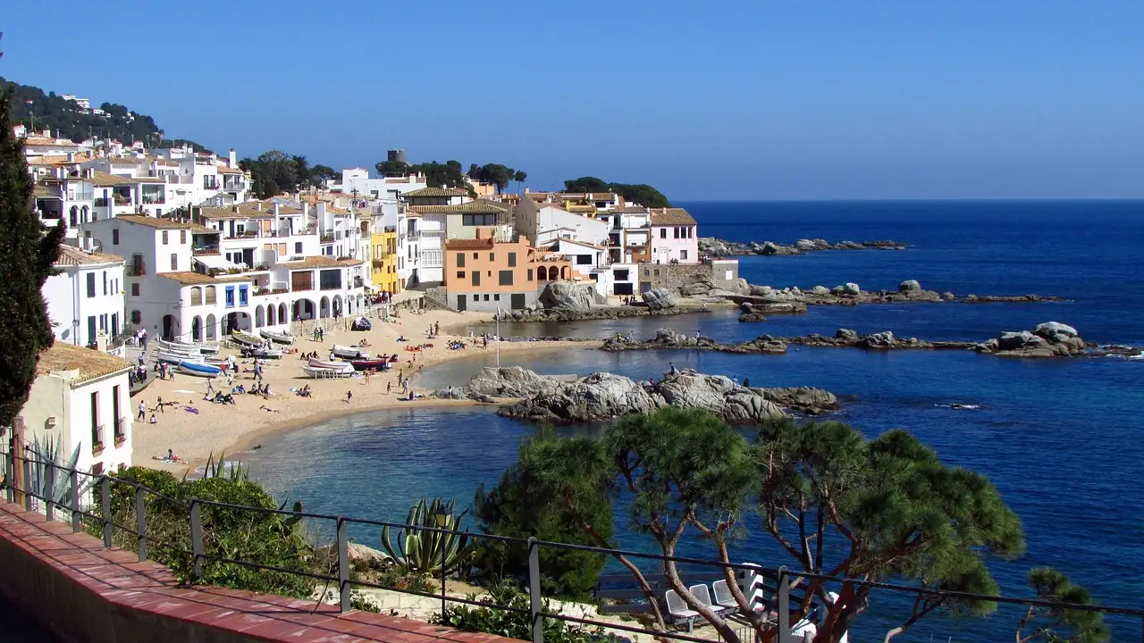 The white houses of Calella de Palafrugell around a small sandy bay on the Costa Brava