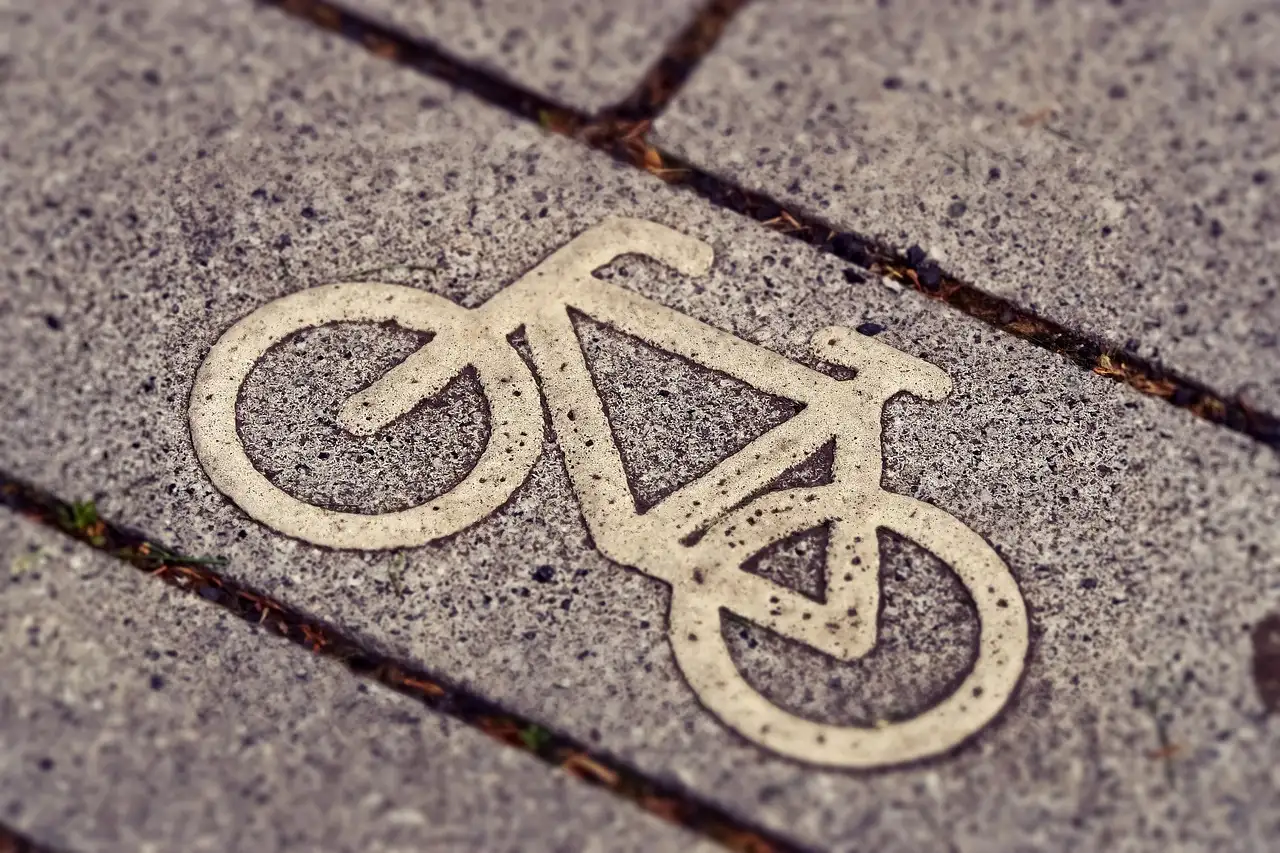 A white bicycle symbol painted on a paved bike lane