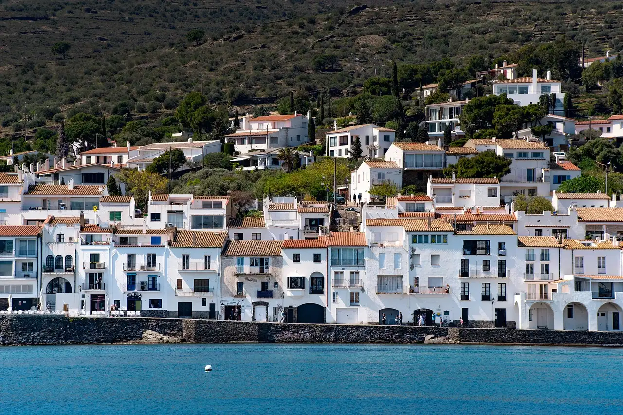 White houses with tiled roofs along the waterfront of Cadaqués