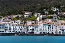 White houses with tiled roofs along the waterfront of Cadaqués