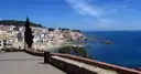 White houses along the seafront of Calella de Palafrugell above a blue bay