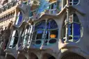 The curved stone window frames and colored glass on the main floor of Casa Batlló