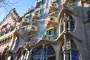 The mosaic facade of Casa Batlló with its bone-shaped balconies and large windows