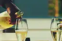 Sparkling wine being poured into flutes