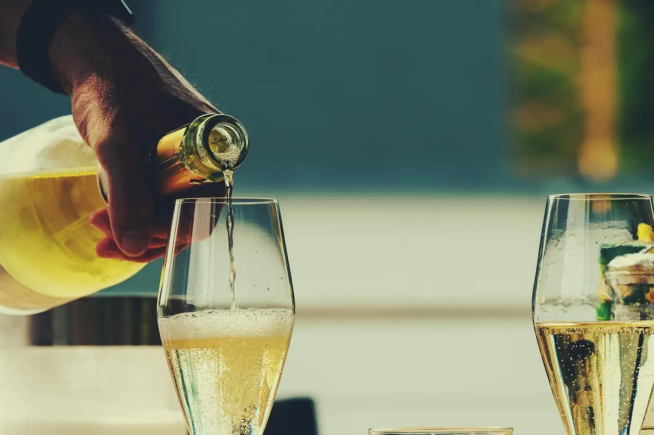 Sparkling wine being poured into flutes