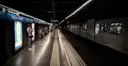 A metro train waiting at the Sagrada Família station platform in Barcelona