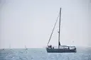 A white sailboat on the calm sea off Barcelona