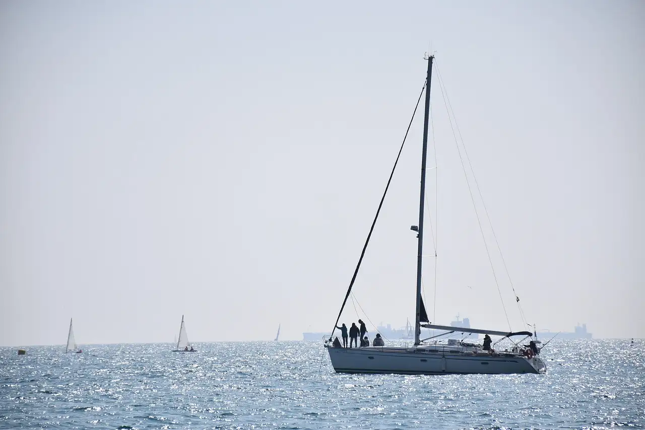 A white sailboat on the calm sea off Barcelona