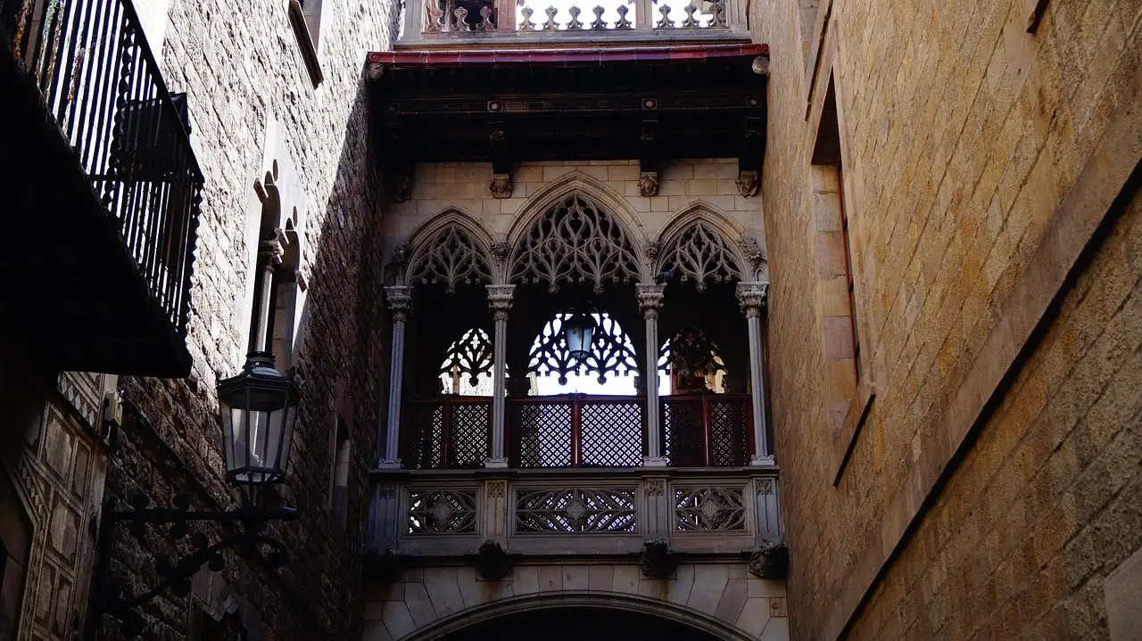 A carved stone bridge over a narrow lane in the Gothic Quarter
