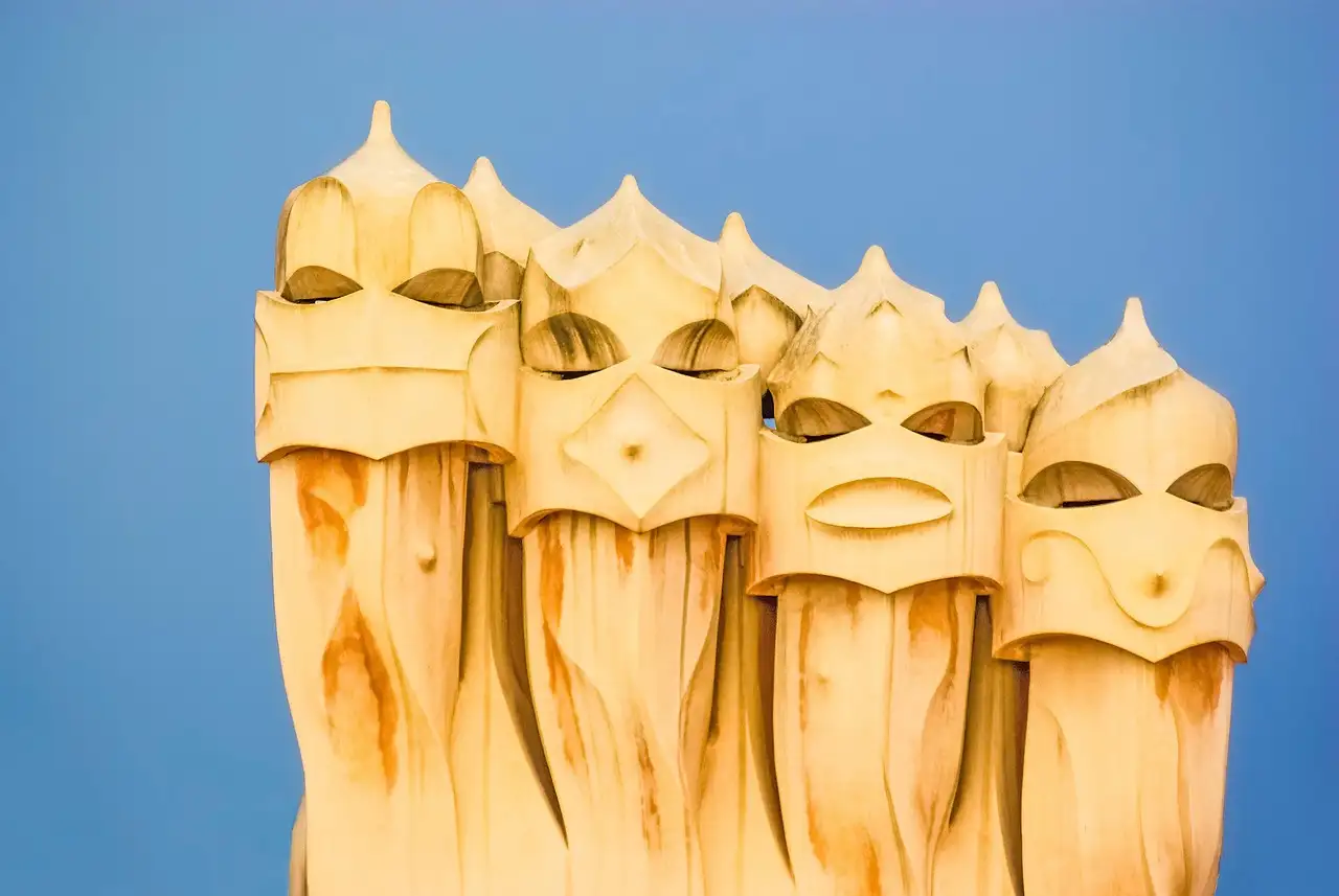 The helmet-shaped chimneys on the roof of La Pedrera against a blue sky