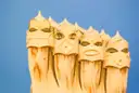 The helmet-shaped chimneys on the roof of La Pedrera against a blue sky