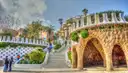 The mosaic stairway and stone arches at the entrance of Park Güell