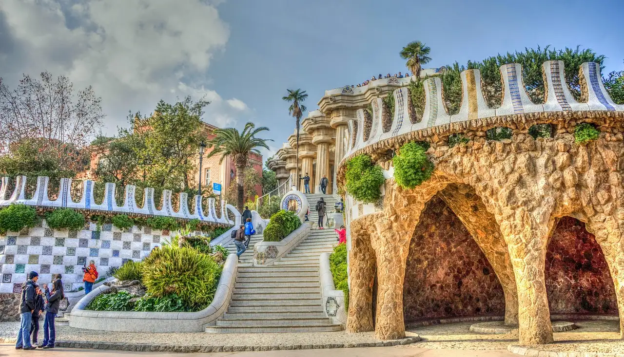 The mosaic stairway and stone arches at the entrance of Park Güell