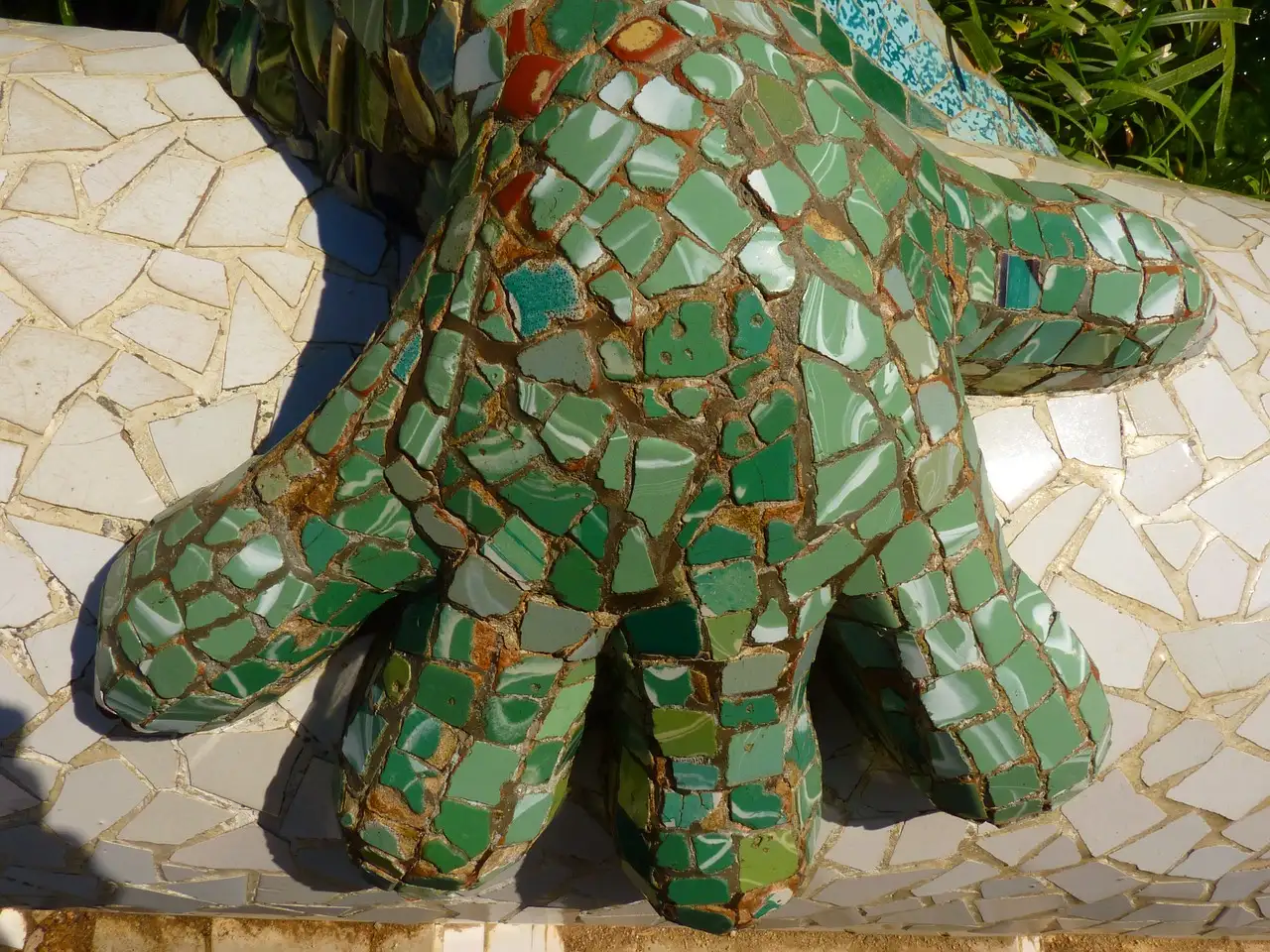 Close view of a green tile mosaic on a sculpture in Park Güell