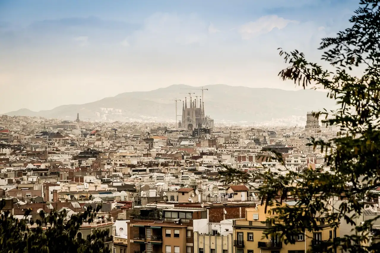 The Sagrada Familia rising above the Barcelona skyline, mountains beyond