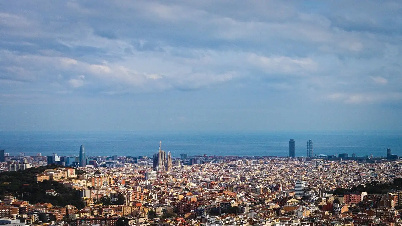 The Barcelona skyline with the sea beyond, seen from a hilltop