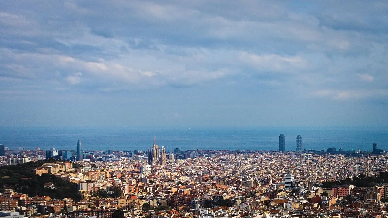 The Barcelona skyline with the sea beyond, seen from a hilltop