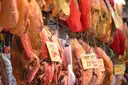 Cured Spanish ham legs hanging with price tags