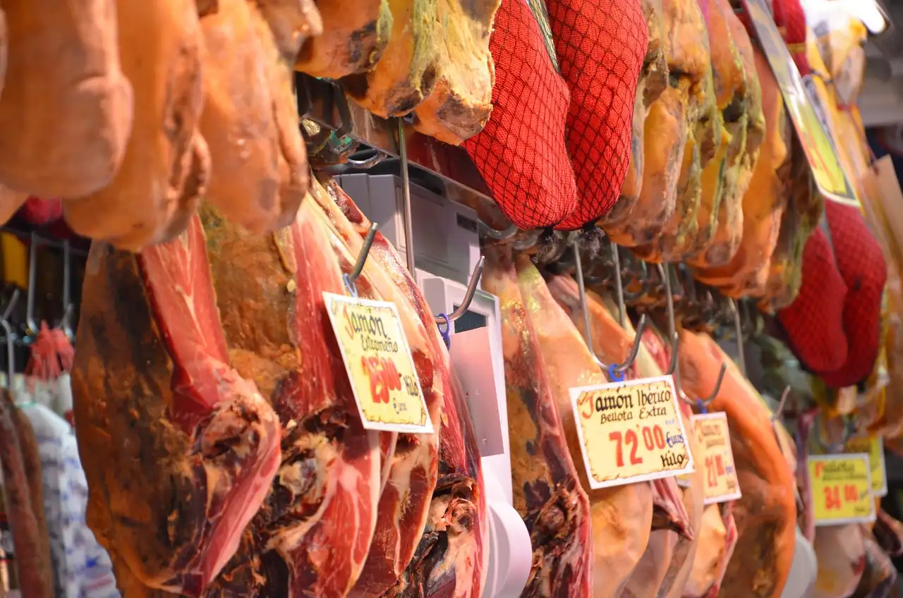 Cured Spanish ham legs hanging with price tags