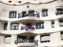 The pale stone facade of La Pedrera with dark wrought-iron balconies
