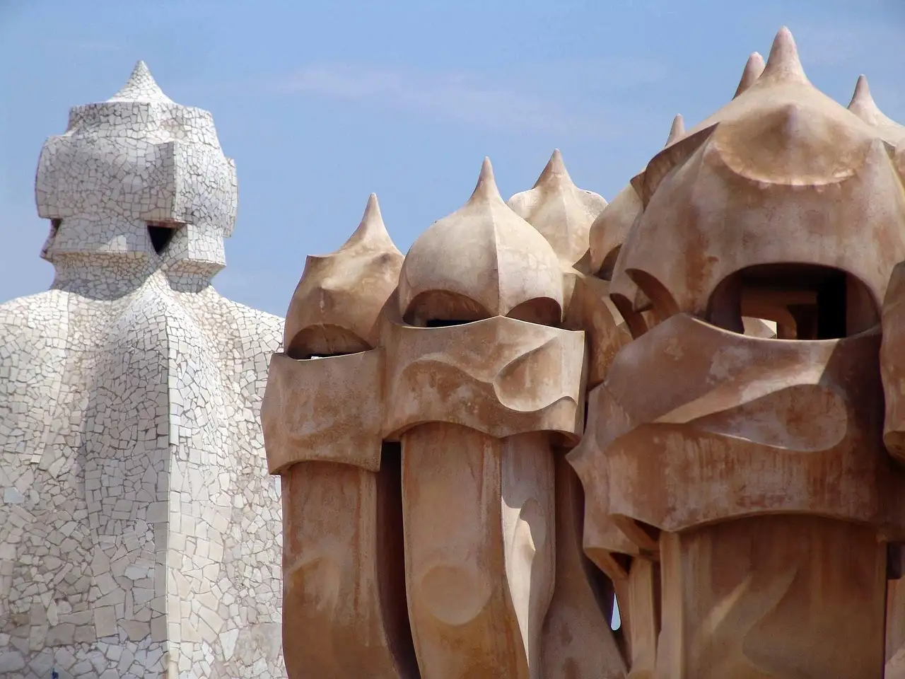 Chimneys on the roof of La Pedrera, some covered in white broken tiles