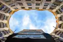 Looking up from the inner courtyard of La Pedrera to a patch of blue sky