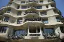 The wavy stone facade of La Pedrera with its twisted iron balconies, seen from below