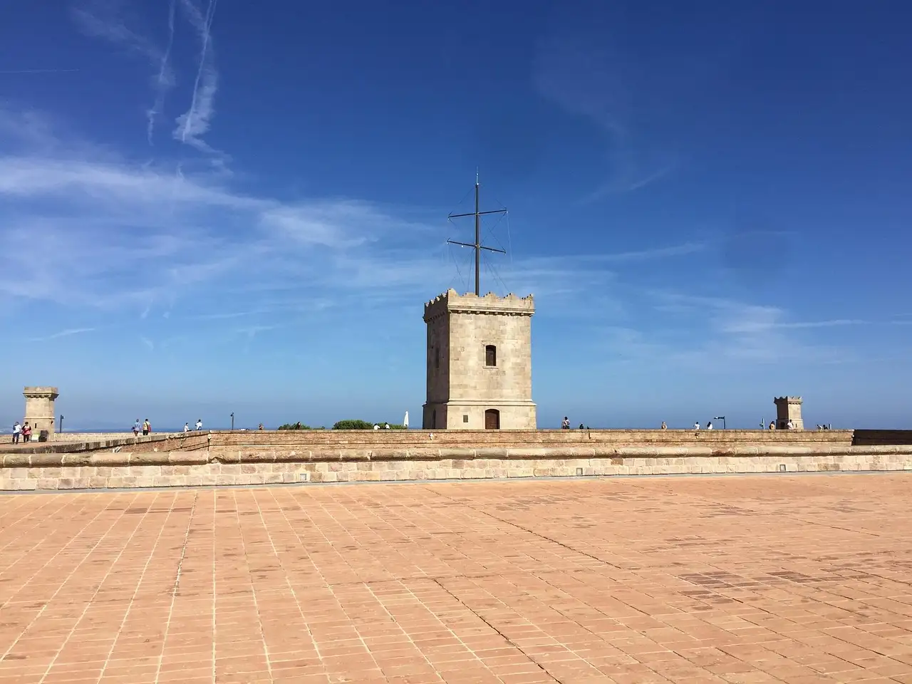 Watchtower on the stone terrace of Montjuic Castle under a blue sky