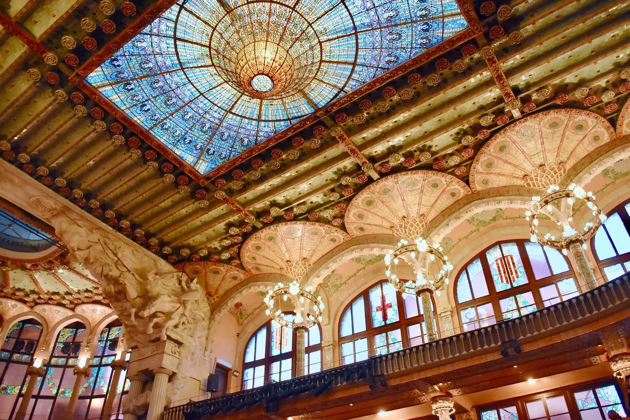 The concert hall of the Palau de la Música Catalana, with its stained-glass skylight, arches and chandeliers