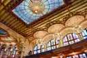The concert hall of the Palau de la Música Catalana, with its stained-glass skylight, arches and chandeliers