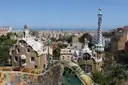 The two gatehouses of Park Güell with their mosaic roofs, above the rooftops of Barcelona
