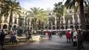 Palm trees and fountain in Placa Reial, Barcelona, with arcaded buildings