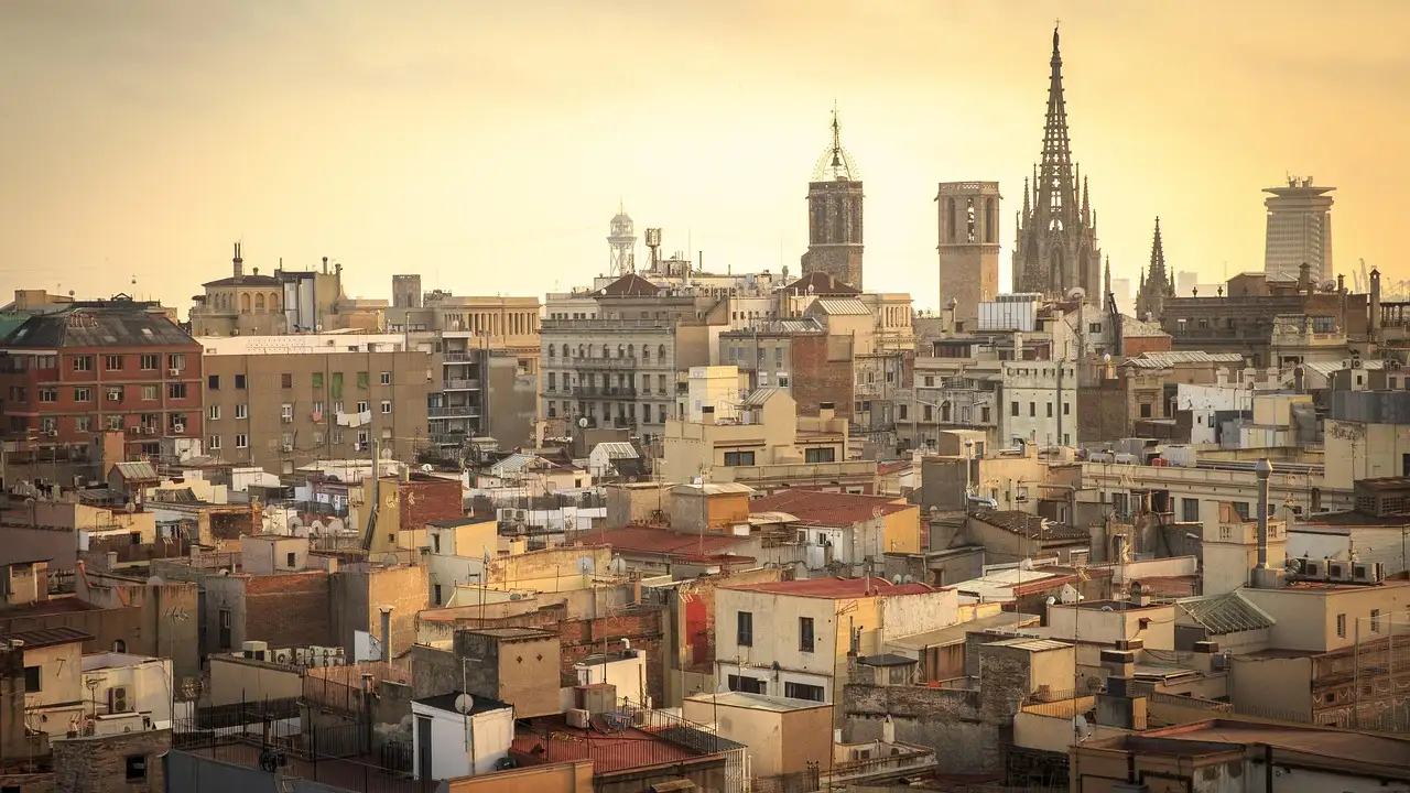 Golden-hour view over Barcelona old-town rooftops and cathedral spires