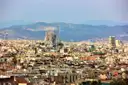 The Sagrada Família towers above the roofs of Barcelona, with hills behind
