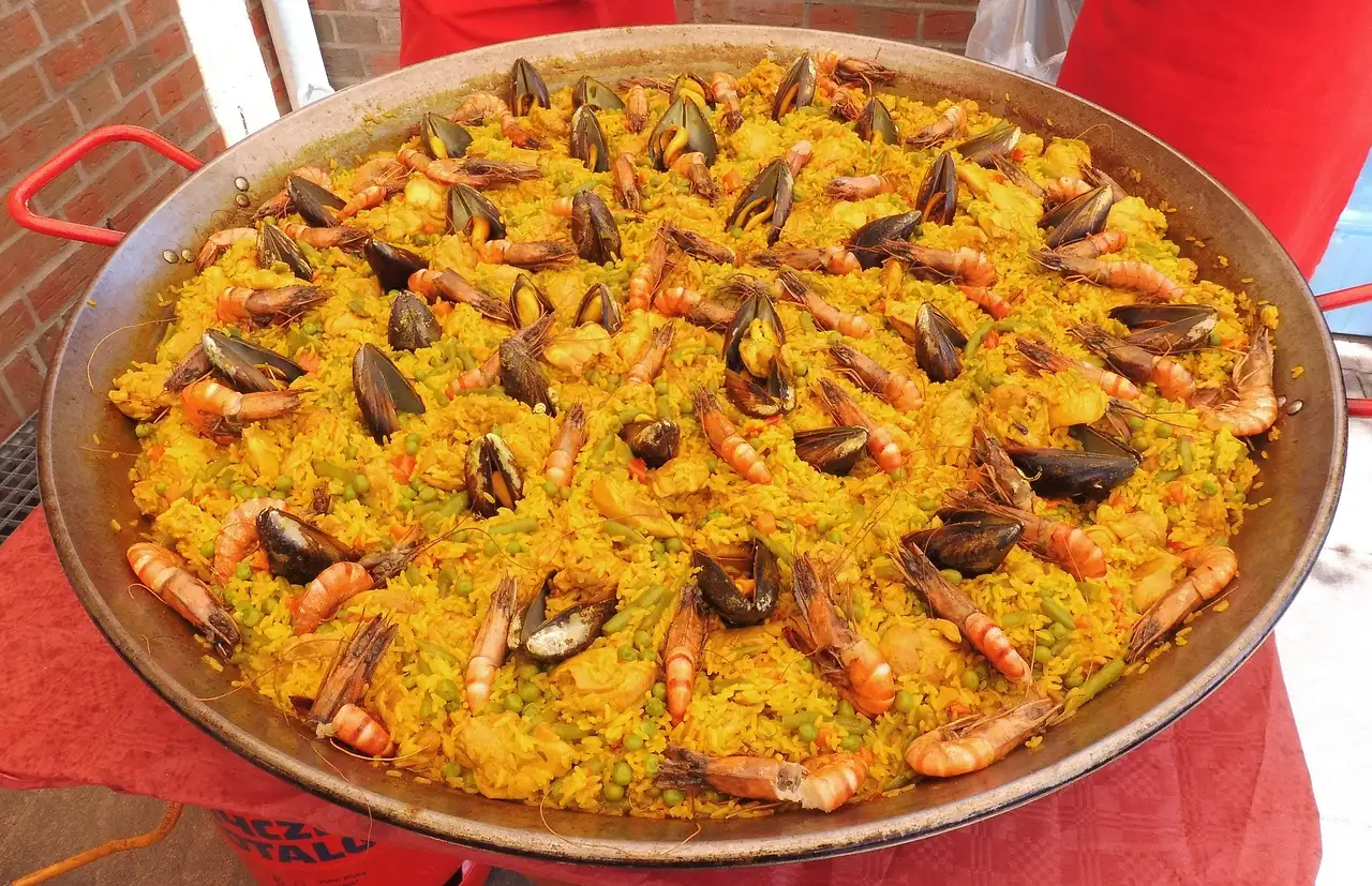 Large pan of saffron paella with mussels and prawns