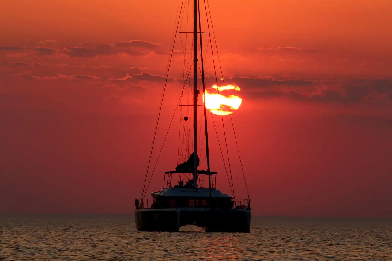 Catamaran silhouette on the sea at a red sunset