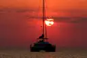 Catamaran silhouette on the sea at a red sunset