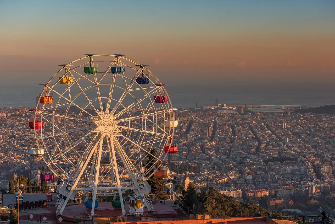 The Tibidabo Ferris wheel above the rooftops of Barcelona at dusk
