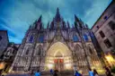 The Gothic front of Barcelona Cathedral at dusk, seen from the square below
