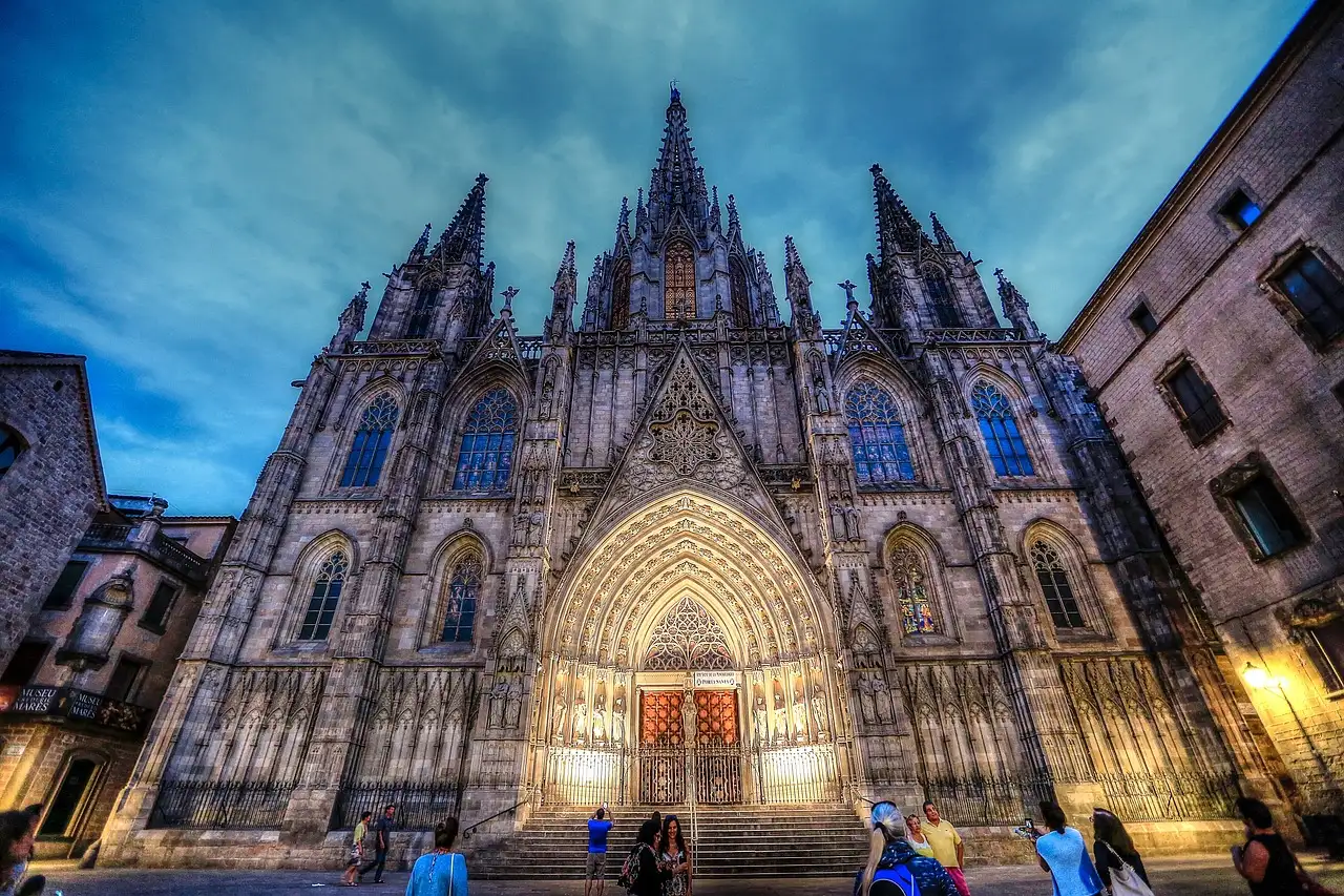 The Gothic front of Barcelona Cathedral at dusk, seen from the square below