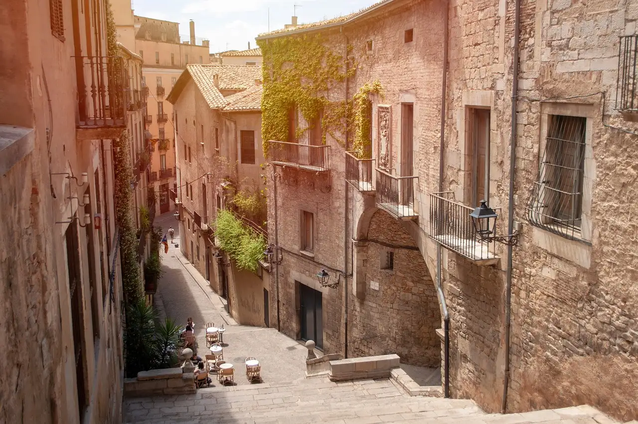 Stone steps climbing between old stone houses in Girona's old town