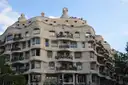The wavy stone front of La Pedrera in Eixample, with iron balconies